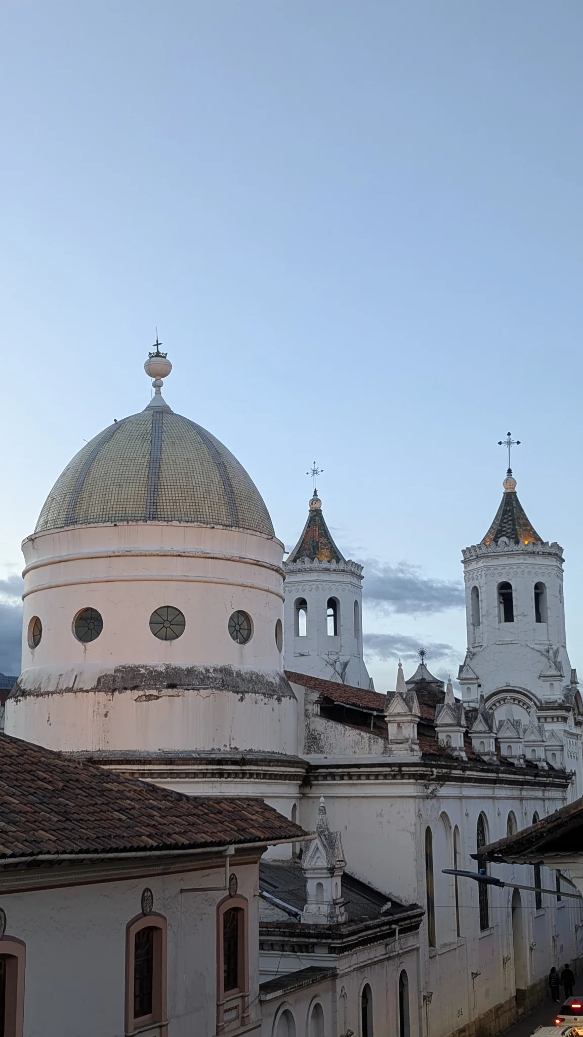 Church domes and towers rise against a clear blue sky.