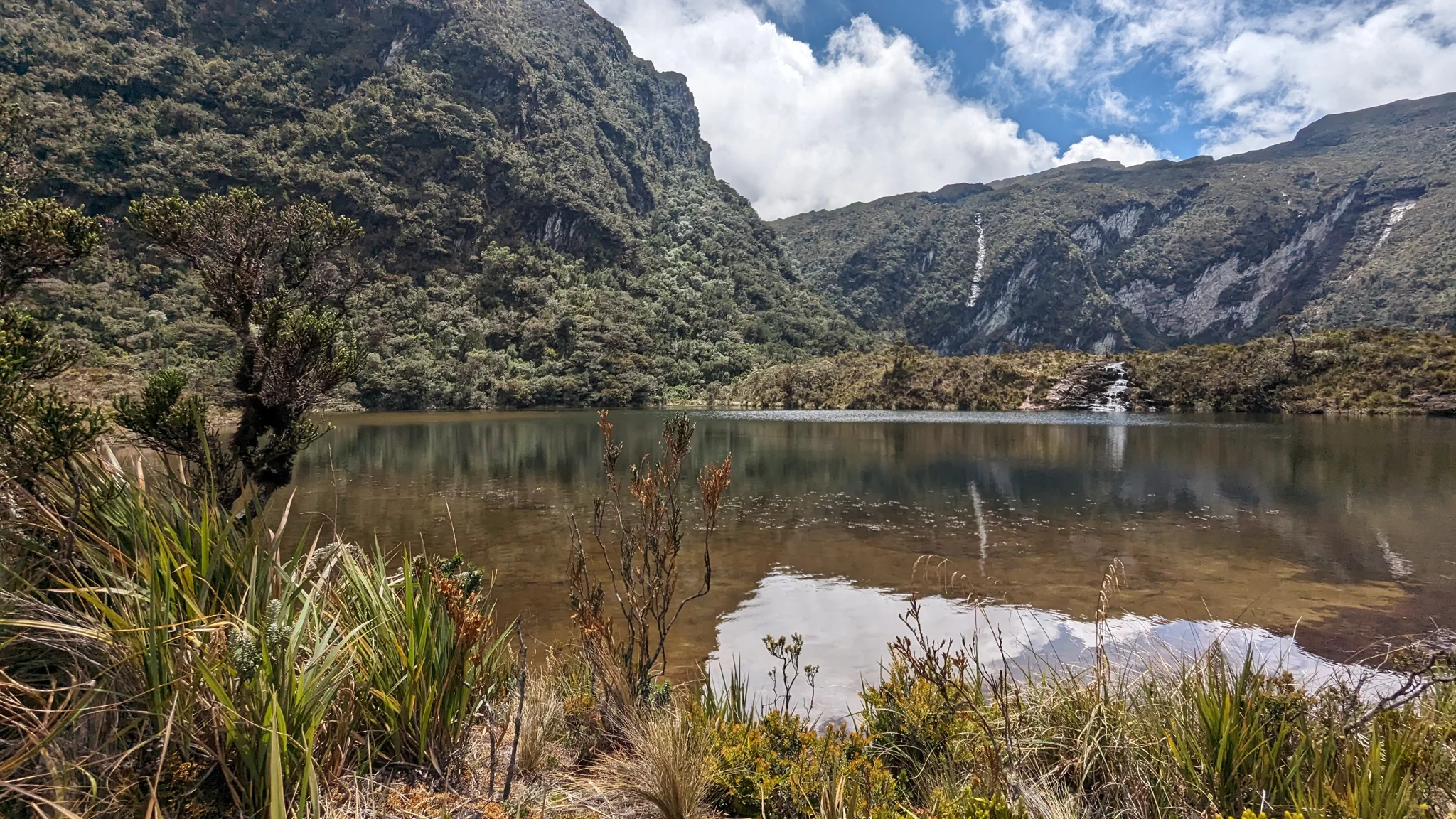 Small lake below rocky hills. The water body is not securely named.
