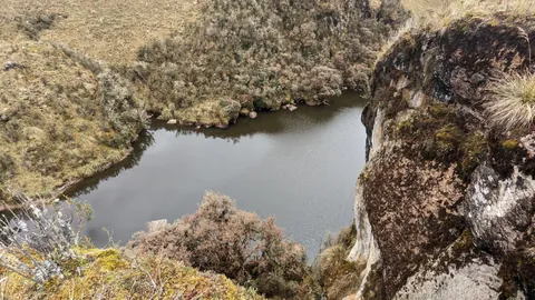 Laguna Pizarro beyond the rocky edge.