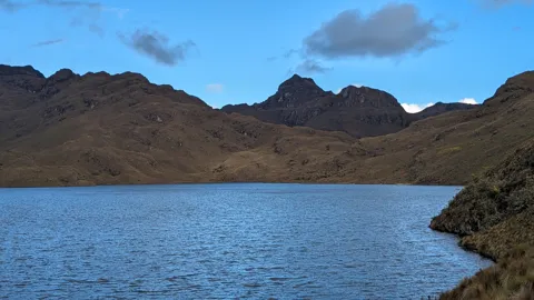 A blue lake beneath dark ridges