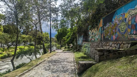 A painted wall beside a park path