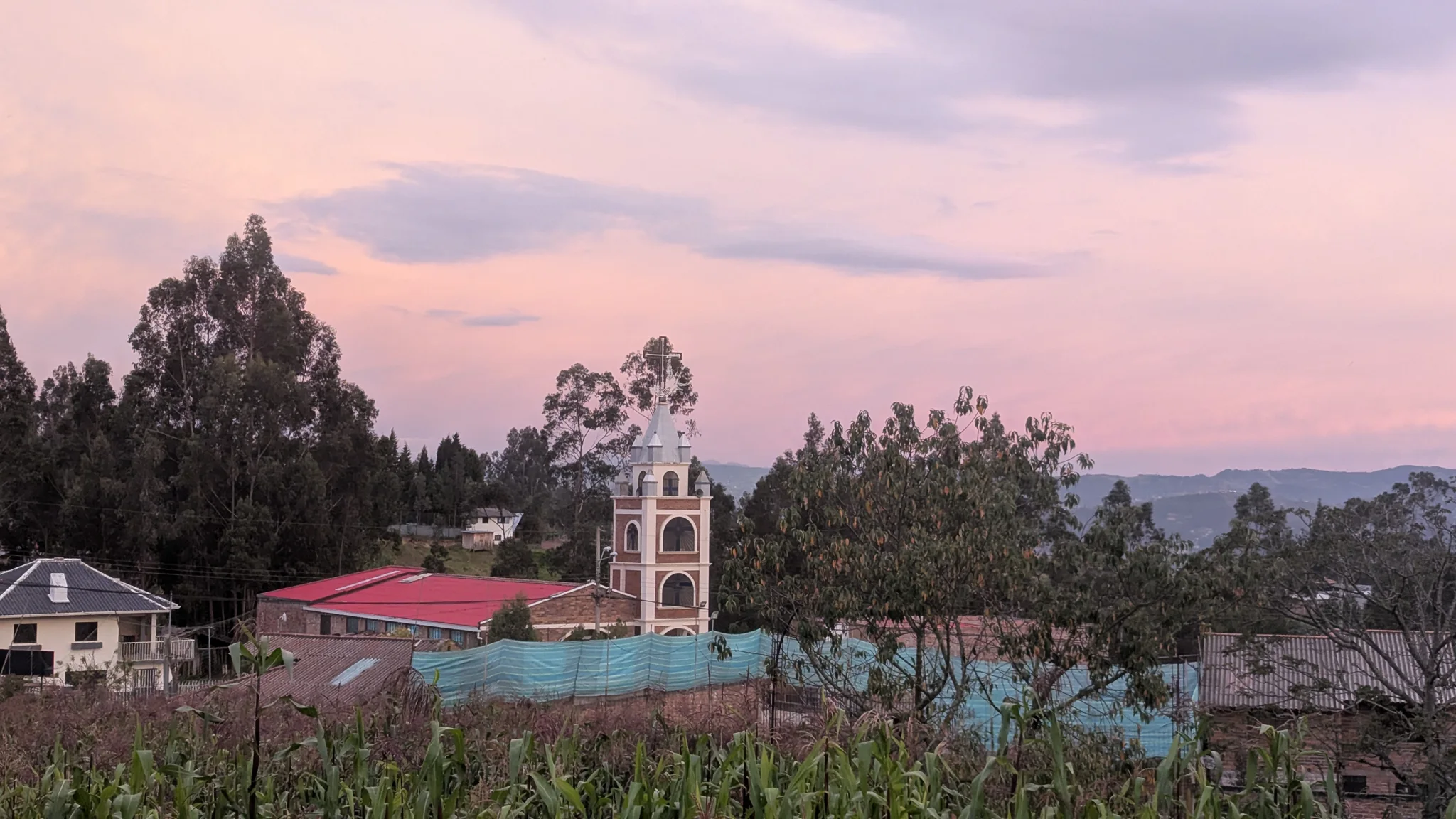 A church tower beneath soft pink clouds
