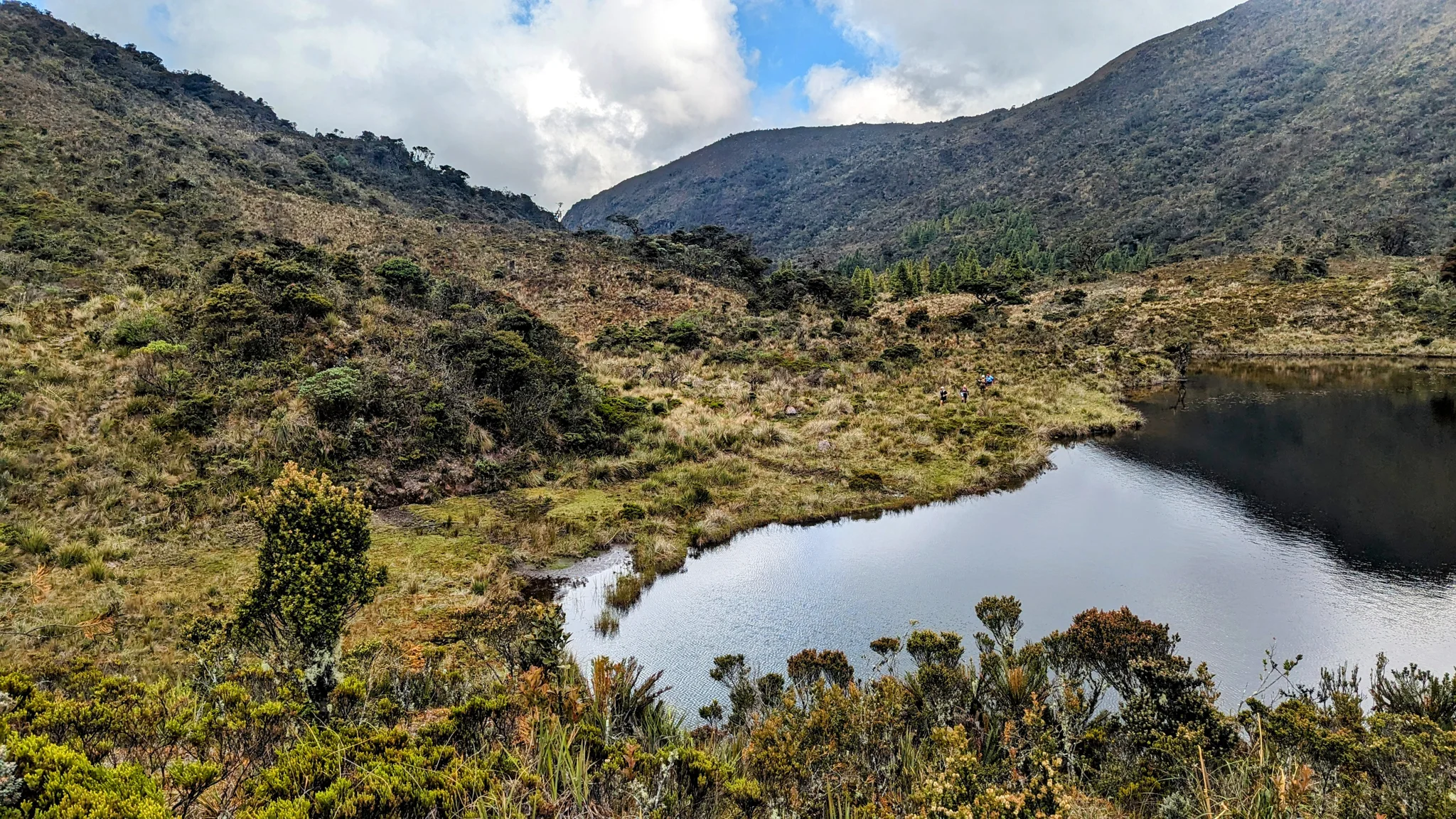 Highland pond below cloudy mountains. The water body is not securely named.