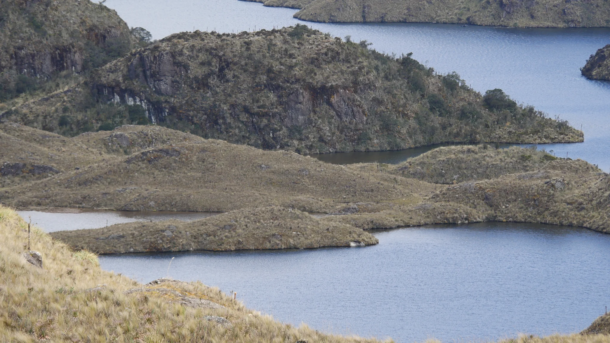 Highland lakes divided by a grassy peninsula. The water body is not securely named.