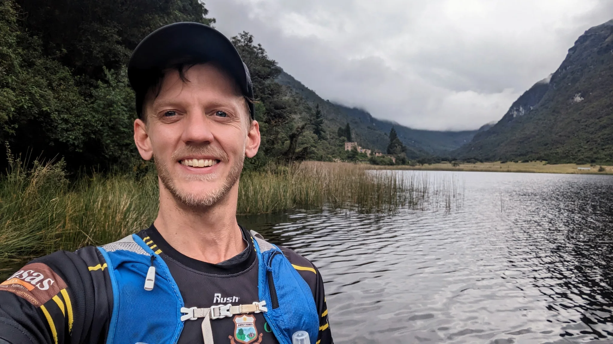 Adult runner selfie by lake.