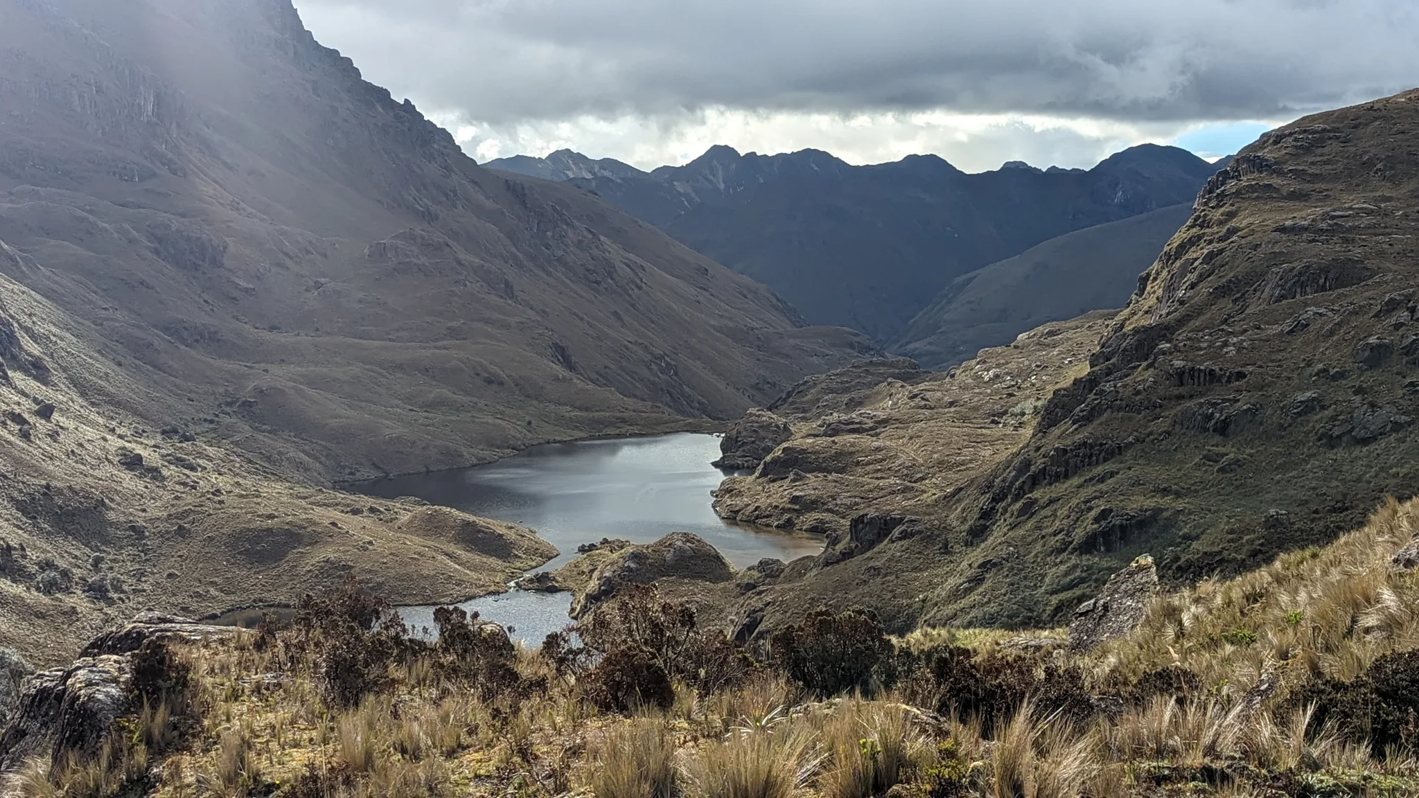 Highland lake in dark valley.