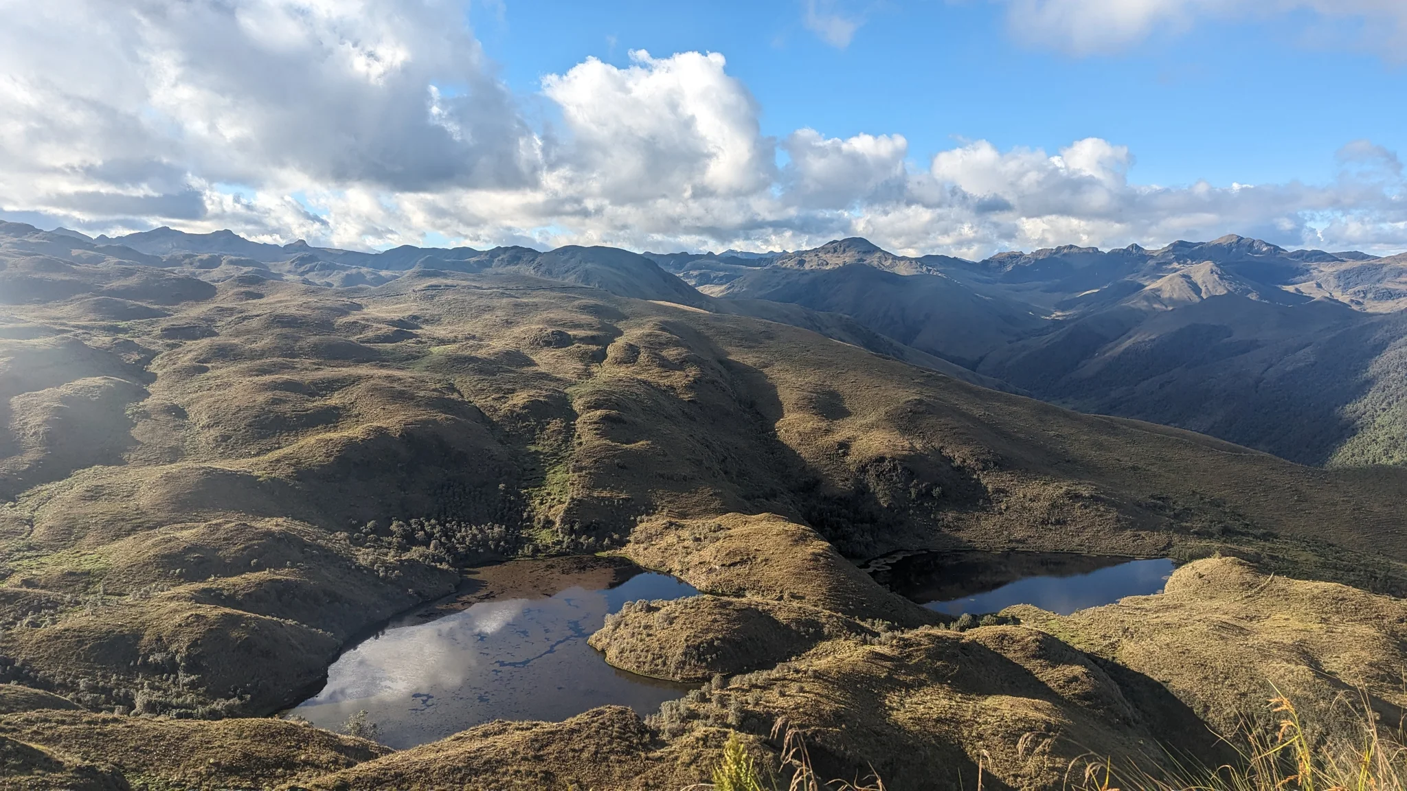 Highland lakes and rolling mountain ridges. The water body is not securely named.