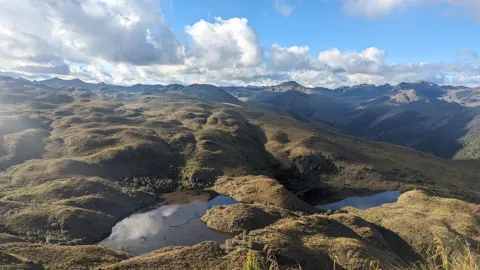 Highland lakes and rolling mountain ridges. The water body is not securely named.