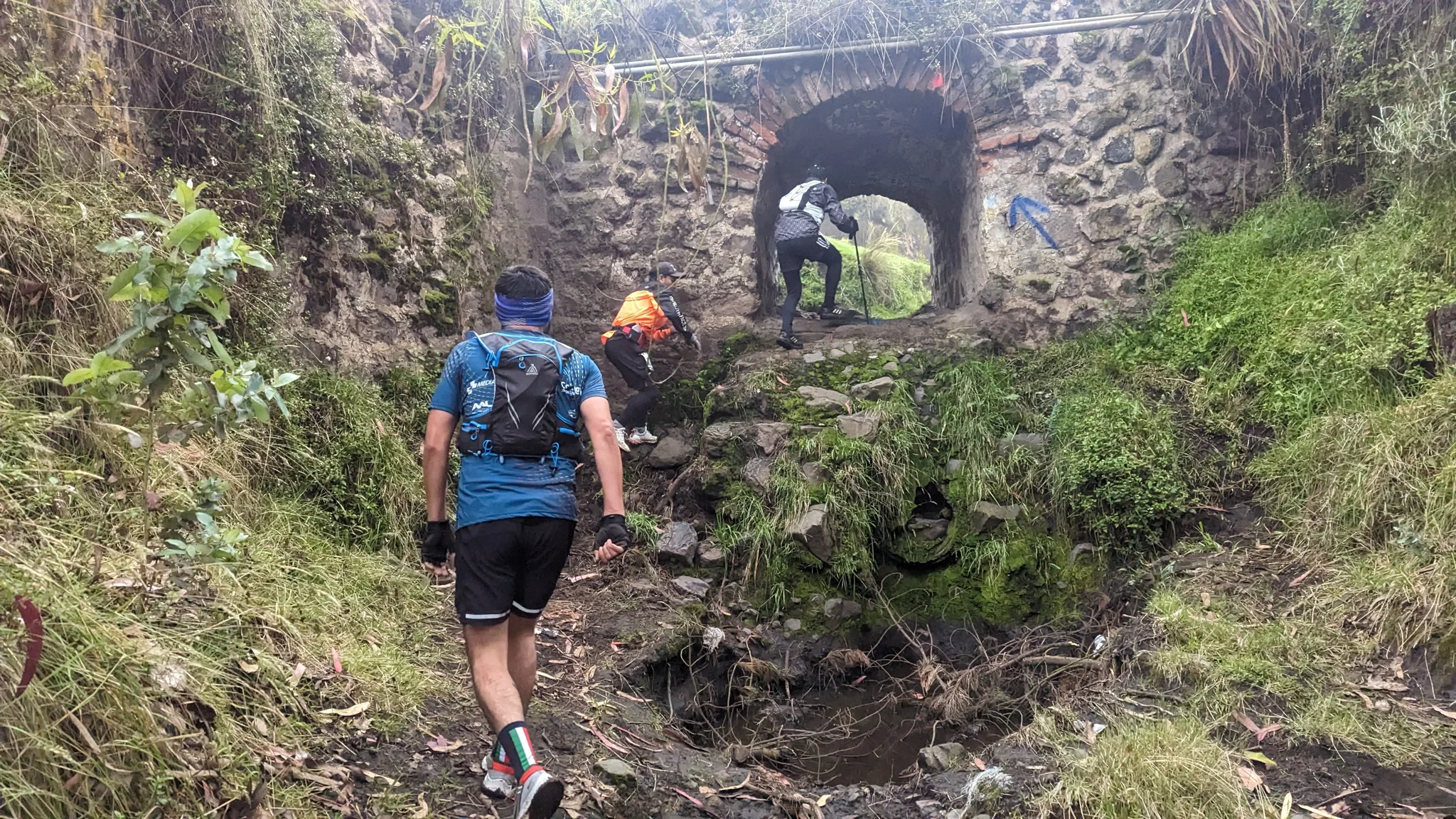 A muddy approach to a stone arch