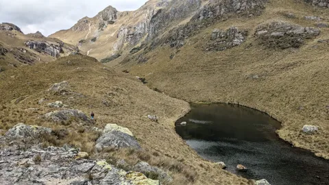 Mountain lake below rocky peaks. The water body is not securely named.