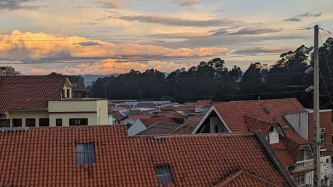Red-tiled roofs beneath an evening sky