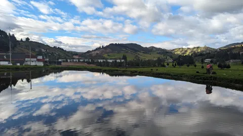 Still lake reflecting clouds. The water body is not securely named.