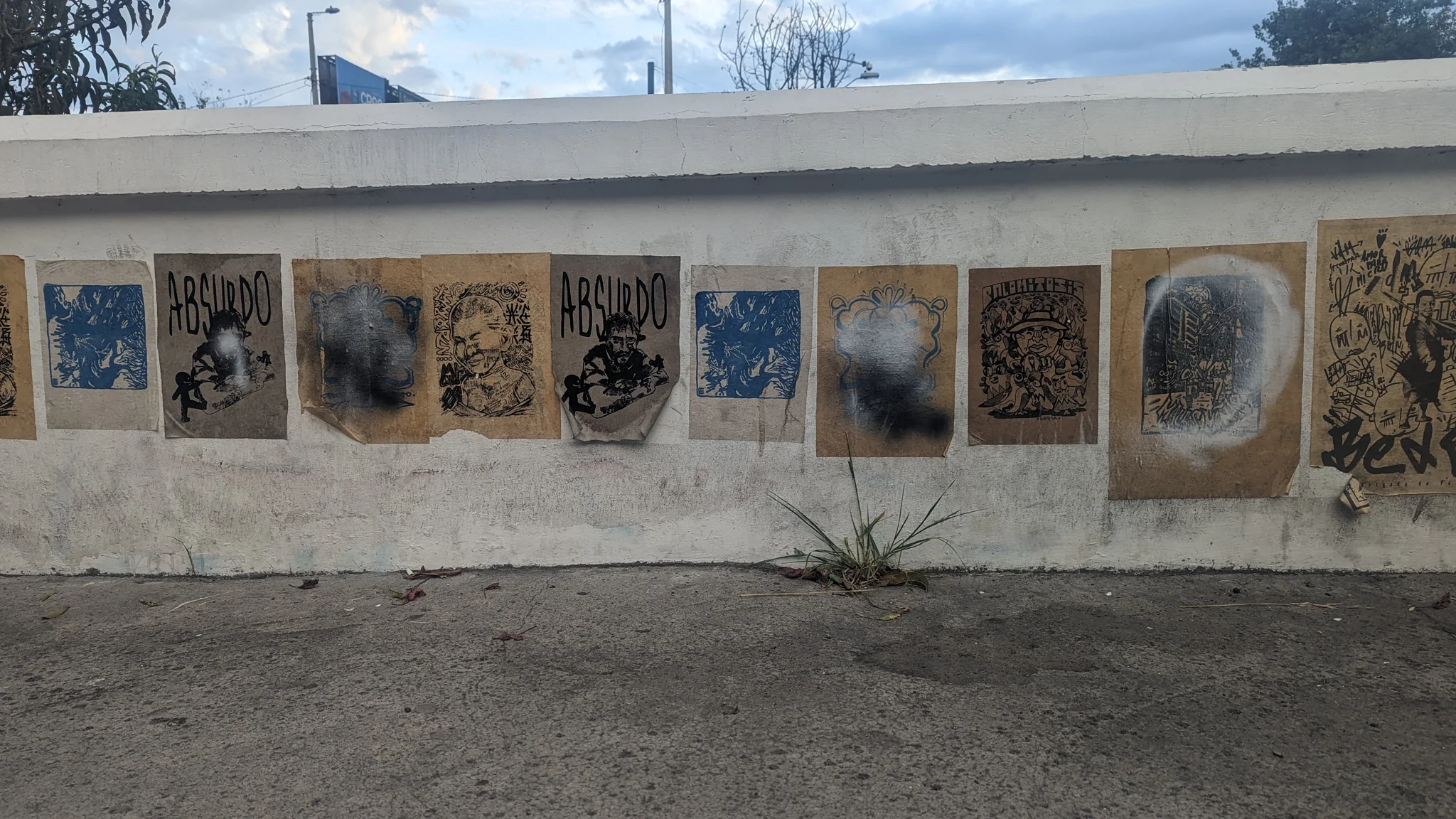 A row of framed wall paintings