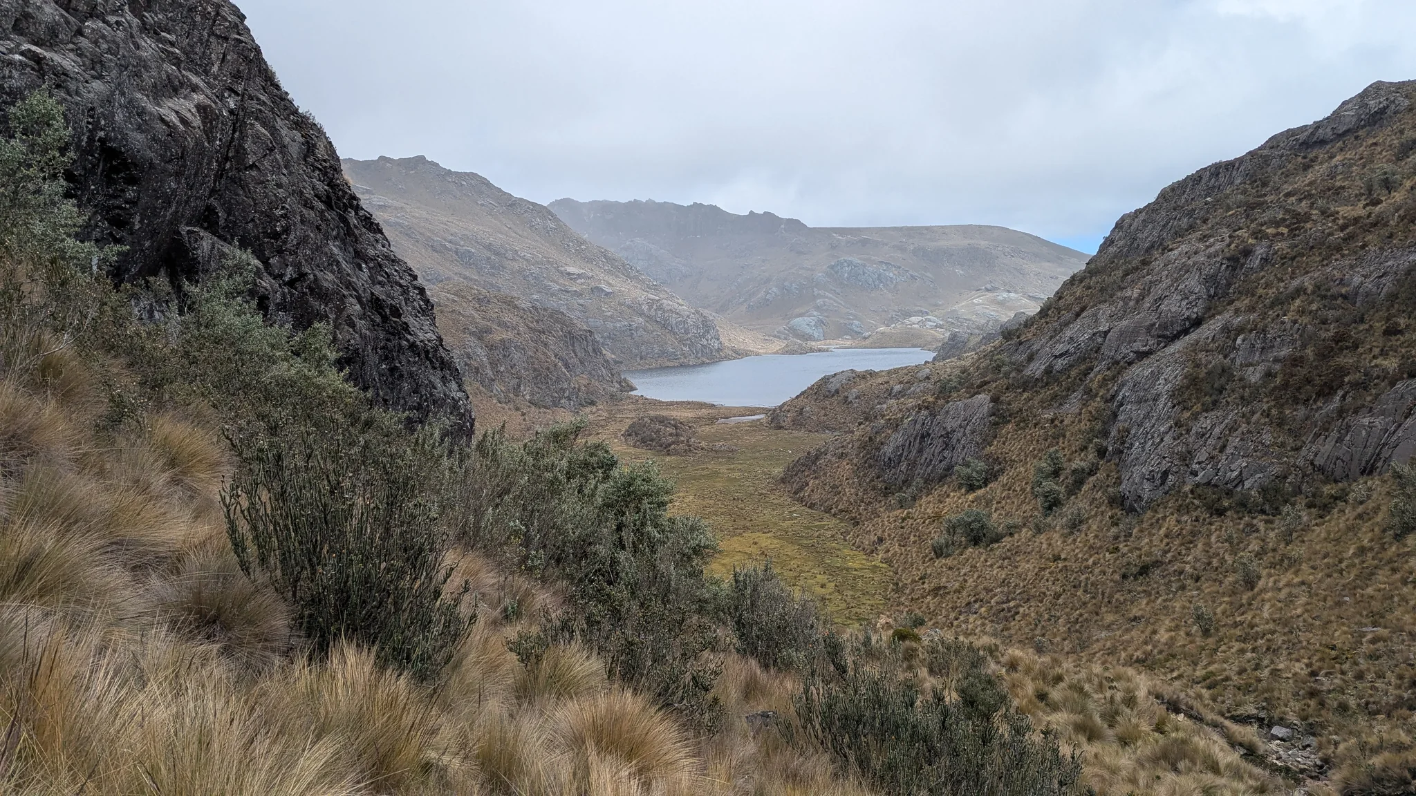 Estrellascocha glimpsed through a rocky pass.
