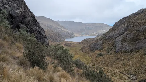 Estrellascocha glimpsed through a rocky pass.