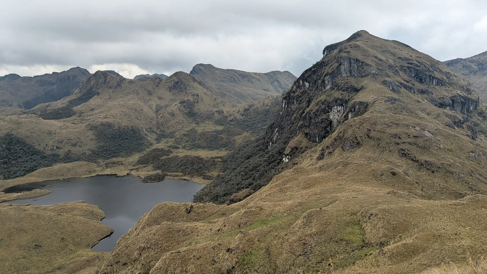 A lake tucked below steep slopes