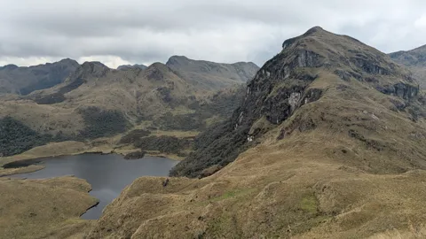 A lake tucked below steep slopes
