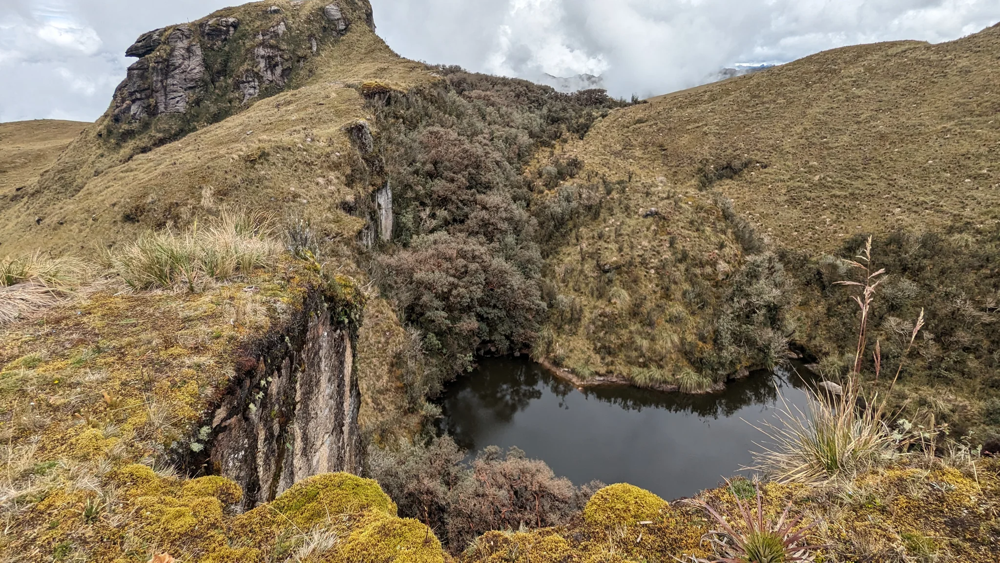Laguna Pizarro beneath a rocky outcrop.