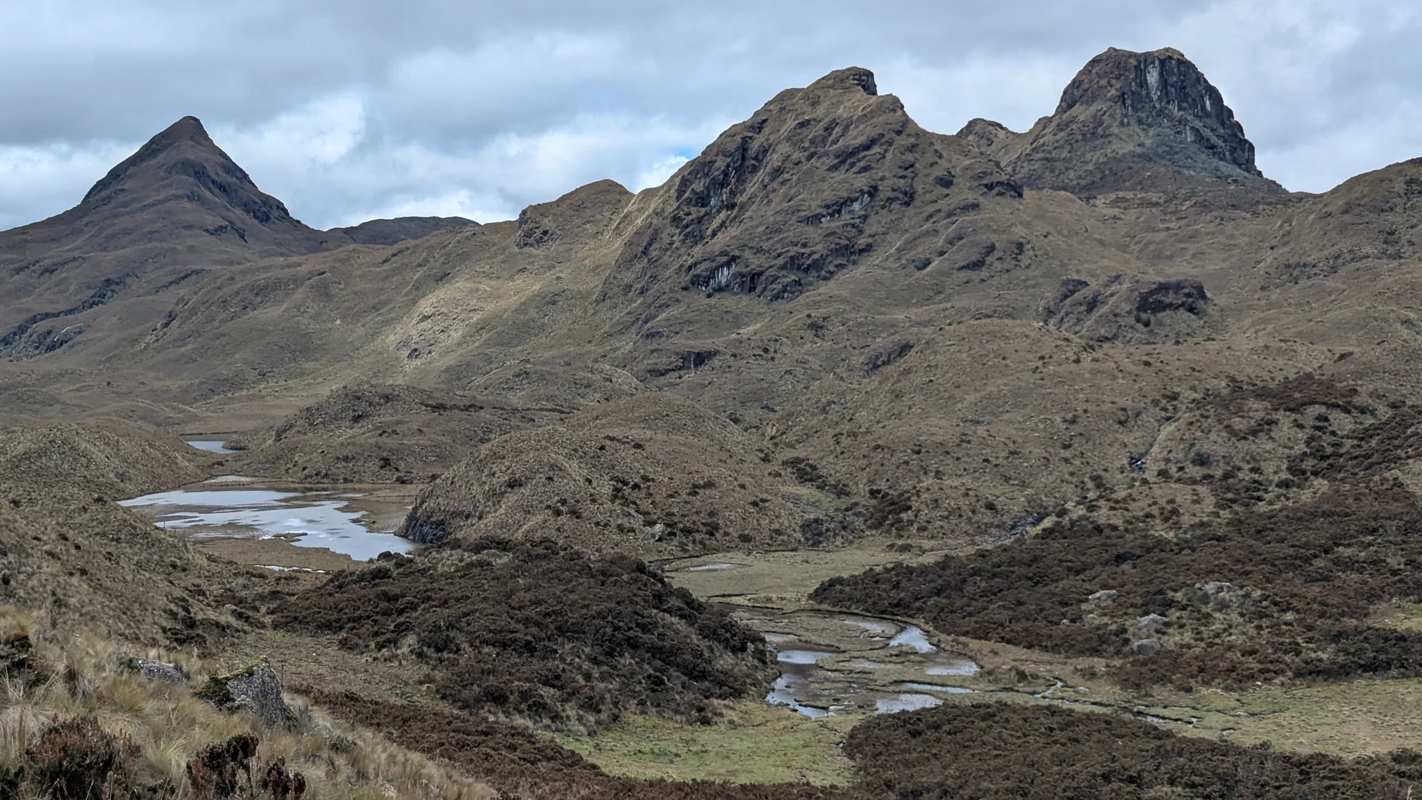 Small wetland beneath rocky summits. The water body is not securely named.