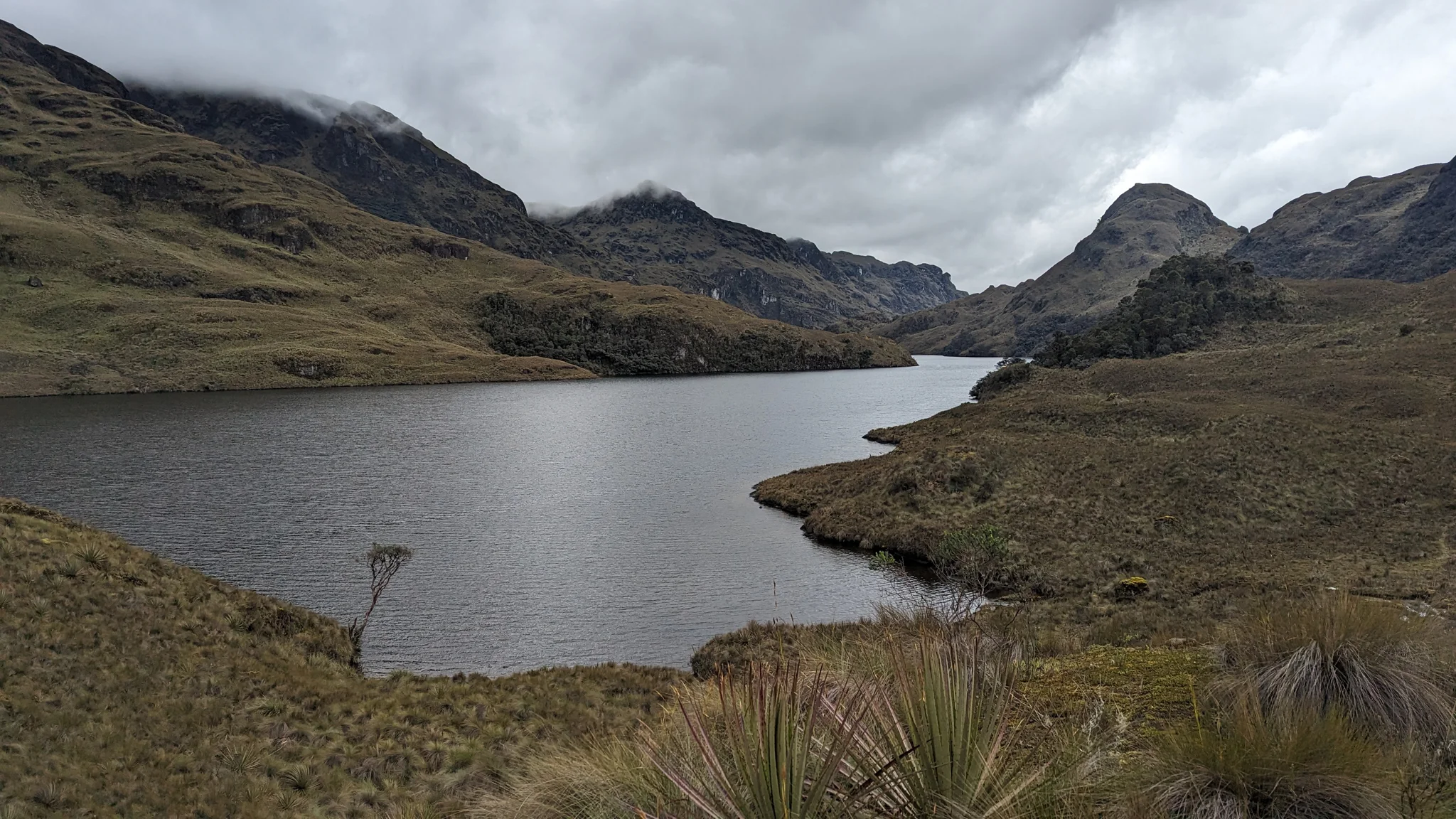 Highland lake below rocky ridges.