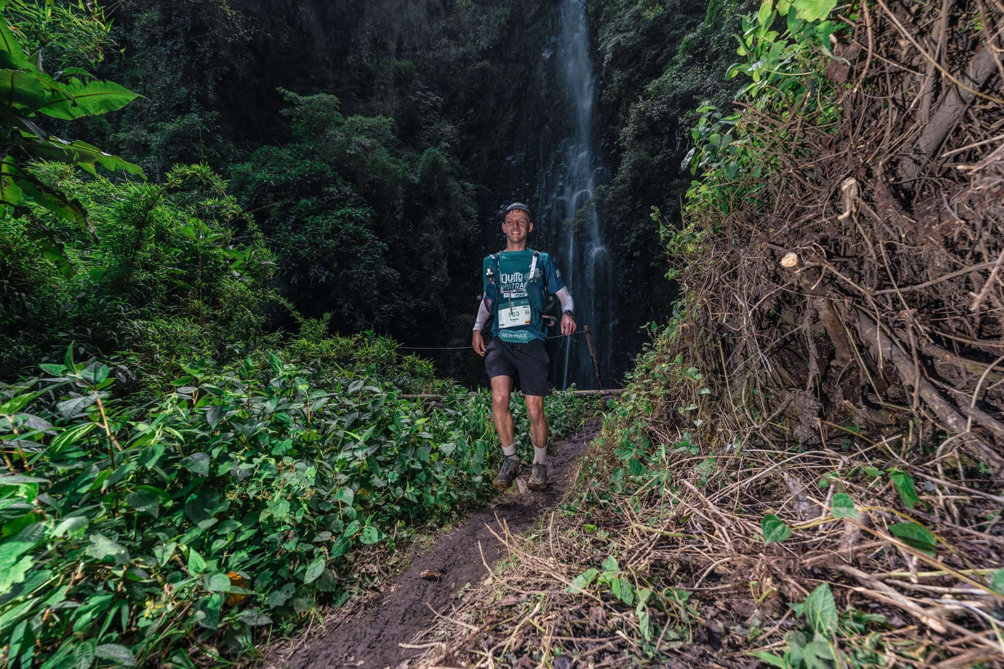 Runner on a narrow green trail