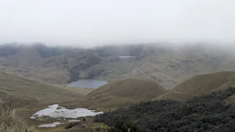 Misty highland lake basin.
