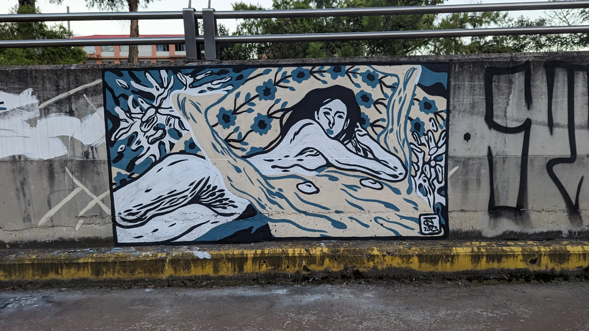 A blue fish mural beneath a railing