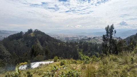 Distant reservoir or lake below a mountain ridge. The water body is not securely named.