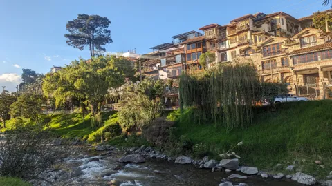 Riverside houses above green banks