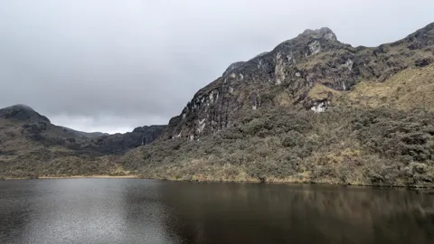 Laguna Espeluznante beneath rocky cliffs.