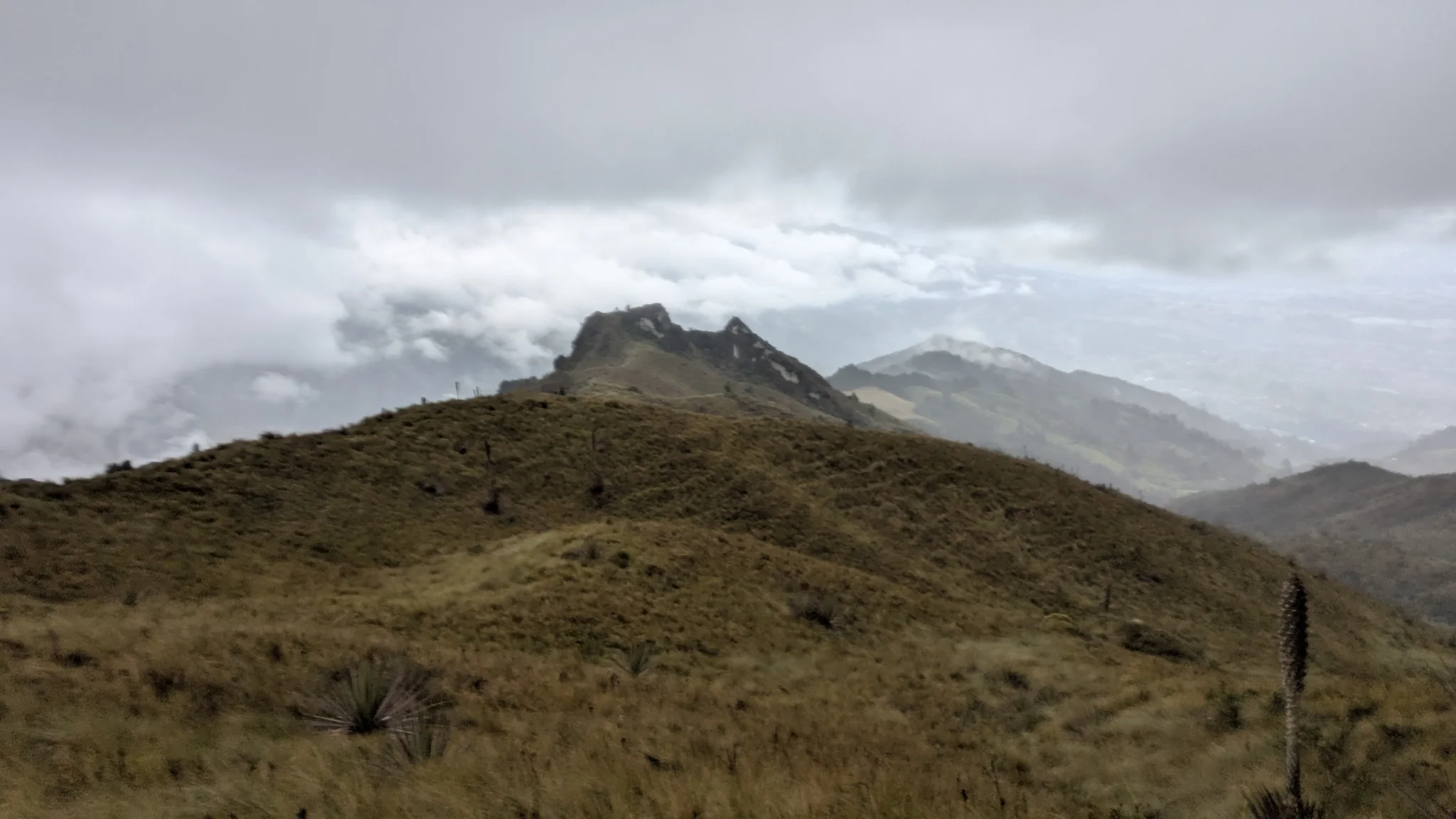 A rounded summit under grey skies