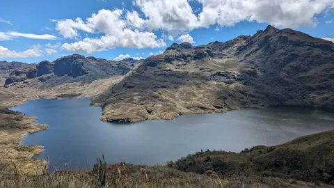 Large lake below jagged peaks.