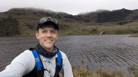 Runner selfie by a dark lake.