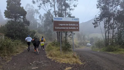 A trail sign in the mist
